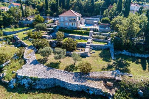 an aerial view of a garden with a house at Villa Oasis Cypress in Čilipi