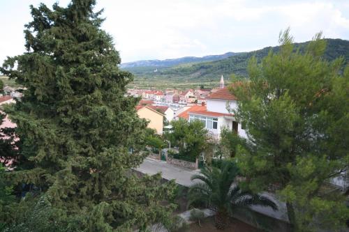 a view of a town through the trees at Apartments Jerković in Stari Grad