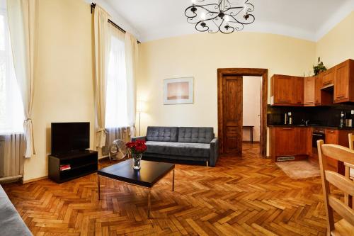 a living room with a couch and a table at Prestige location apartments Pijarska street in Krakow