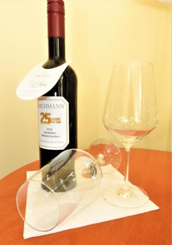 a bottle of wine and a glass on a table at Hotel Residenz Bad Frankenhausen in Bad Frankenhausen