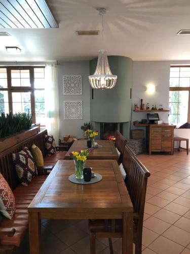 a dining room with a wooden table and chairs at Resort-Restaurant Stilec in Kamenný Újezd