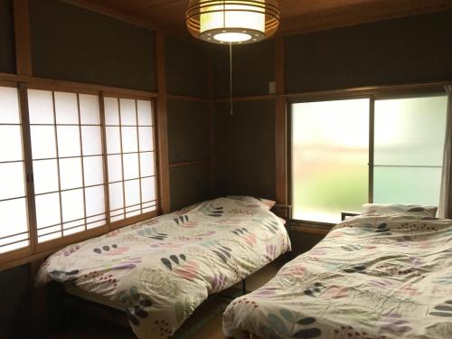 Ένα ή περισσότερα κρεβάτια σε δωμάτιο στο Nikko - House / Vacation STAY 40938