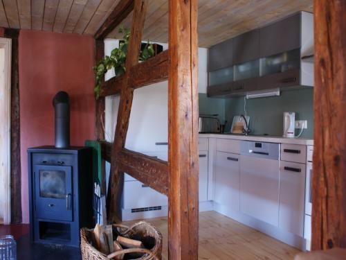 a kitchen with a wood stove in a room at Pferd - Spaß - Entspannung in Staitz