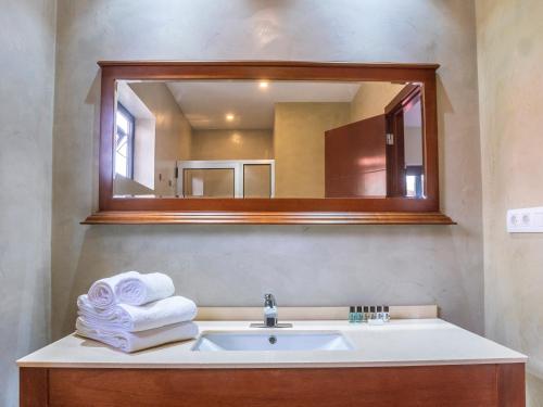 a bathroom with a sink and a mirror at Angulo House in Santa Maria