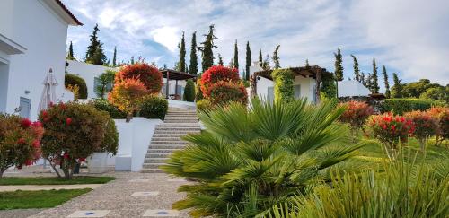 a house with white walls and stairs and plants at BanSala Villas in Vounaria