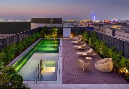 a swimming pool on the roof of a building at Millennium Al Barsha in Dubai