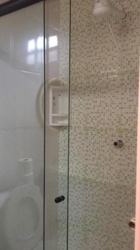 a shower with a glass door in a bathroom at Pousada da Barra - Maraú Bahia in Barra Grande