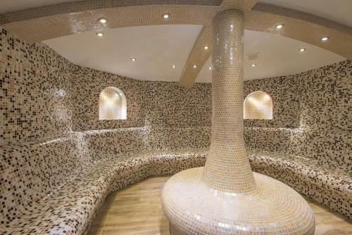 a room with a large vase in the middle of it at Balneo Complex Saint Spas in Velingrad