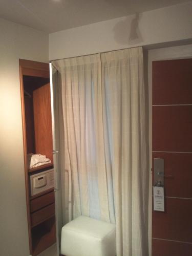 a bathroom with a shower with a white curtain at Telmho Hotel Boutique in Buenos Aires