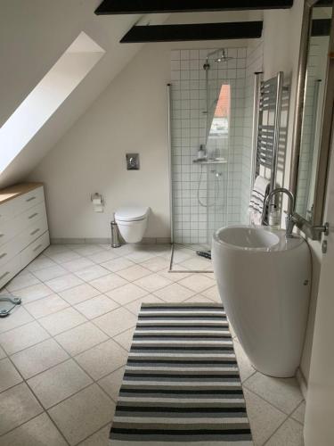 a large bathroom with a tub and a sink at Ebeltoft in Ebeltoft