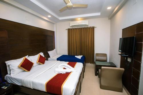 Ένα ή περισσότερα κρεβάτια σε δωμάτιο στο Orion Residency Hotel Near Chennai Central Railway Station