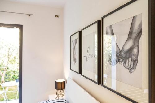 a row of framed pictures on a wall in a room at Alexander B&B in Tortolì