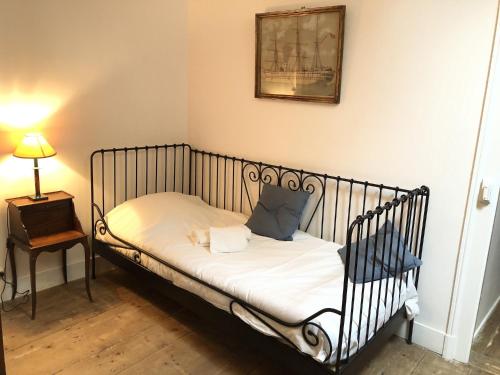a small bed in a room with a picture on the wall at Angel Services - Le Nant in Saint-Jorioz