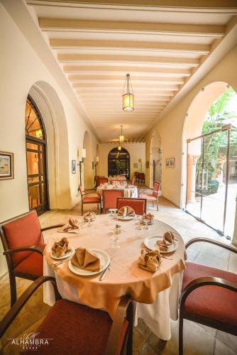 a large dining room with a table and chairs at Alhambra Thalasso in Hammamet