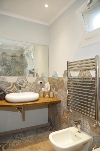 a bathroom with a sink and a toilet at CASA AZZURRA in Imperia