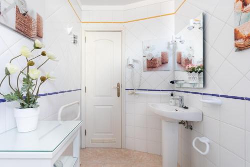 a white bathroom with a sink and a mirror at Vivienda vacacional La Laguna Luxe in Las Lagunas