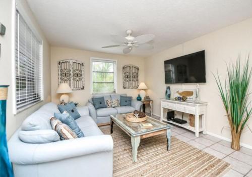 a living room with a couch and a table at Bianco Sands in Siesta Key
