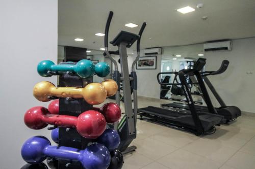 a gym with a rack of balls and a treadmill at Oscar Hotel Executive in Porto Velho