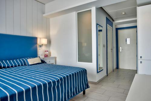a hotel room with a bed and a shower at db Seabank Resort + Spa All Inclusive in Mellieħa