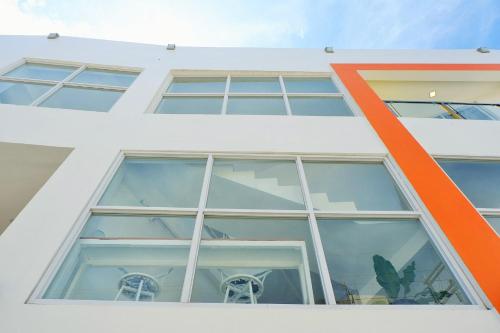 an orange stripe on the side of a white building at Kamusta Boutique Hotel in Boracay