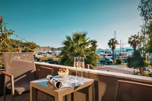 a table on a balcony with a view of a harbor at Hotel Marina Bay Göcek in Göcek