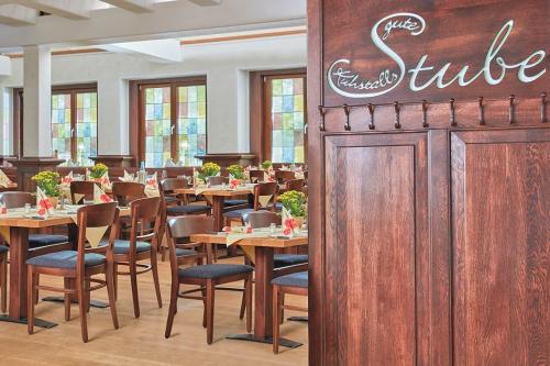 a dining room with wooden tables and chairs at Landhotel Naafs-Häuschen in Lohmar