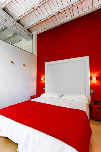 a red bedroom with a white bed and a red wall at Albergo Ristorante Madonnina in Cantello