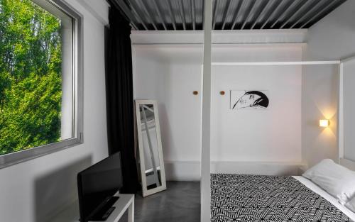 a bedroom with a bed and a mirror and a window at Albergo Ristorante Madonnina in Cantello