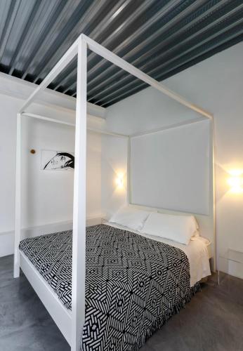 a bedroom with a white canopy bed in a room at Albergo Ristorante Madonnina in Cantello