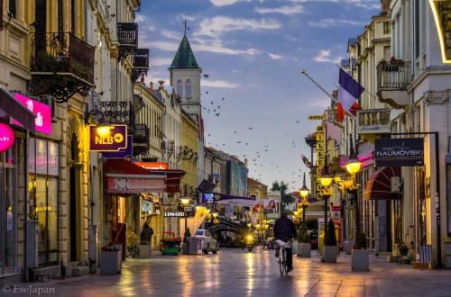 a person riding a bike down a city street at night at Vila Piramida in Bitola
