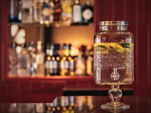 a mason jar filled with liquid sitting on a bar at Hotel Marina Bay Göcek in Göcek