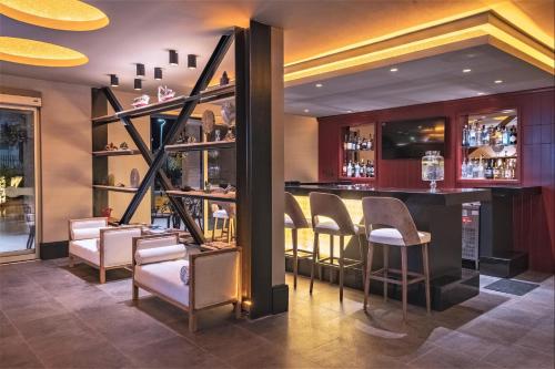 a bar in a restaurant with chairs and tables at Hotel Marina Bay Göcek in Göcek