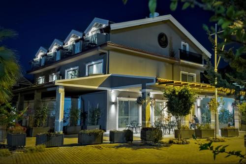 a building with an umbrella in front of it at Hotel Marina Bay Göcek in Göcek