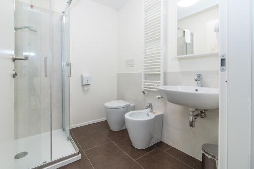 a bathroom with a sink and a toilet and a shower at Hotel Cascina Fossata & Residence in Turin
