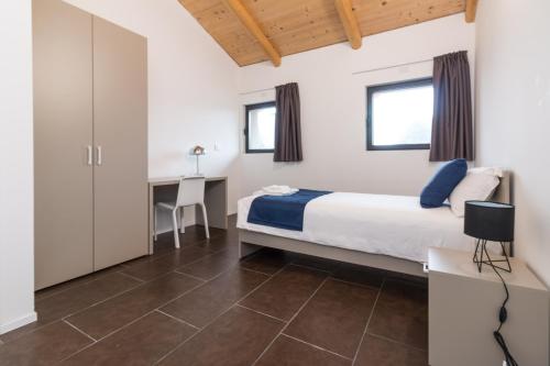 a bedroom with a bed and a desk at Hotel Cascina Fossata & Residence in Turin