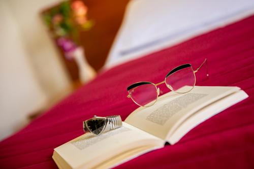a pair of glasses sitting on top of a book at Santa Caterina Hotel & Bike in Chianciano Terme