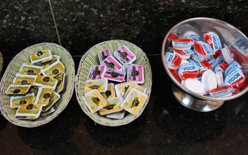 three baskets filled with different types of candy at Pousada Canto Verde in Boicucanga