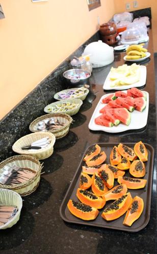 a table with plates of food on a counter at Pousada Canto Verde in Boicucanga