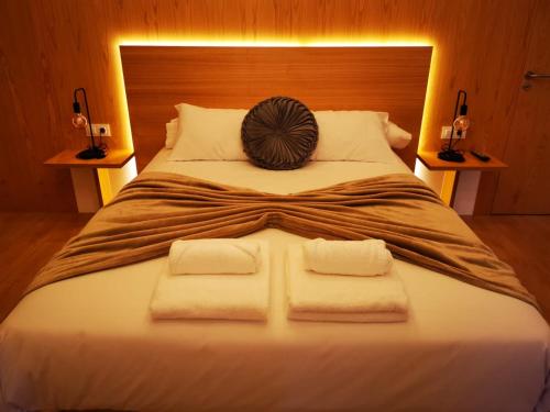 a bedroom with a large bed with towels on it at A Casa da Botica in Samos