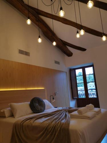 a bedroom with a large bed with towels on it at A Casa da Botica in Samos