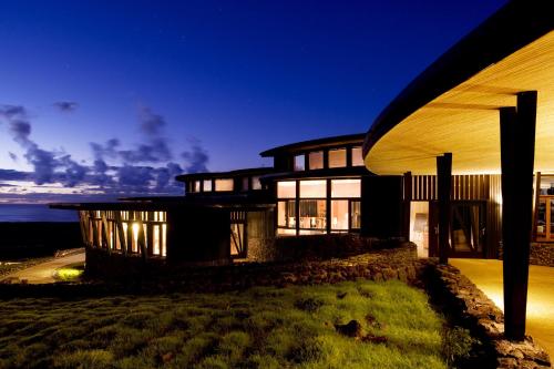 a large house at night with the lights on at Explora en Rapa Nui - All Inclusive in Hanga Roa