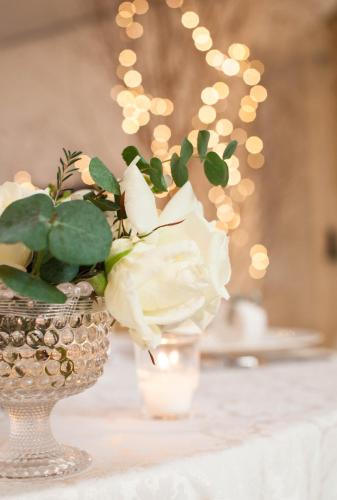 a vase with flowers in it on a table at Albergo Ristorante Madonnina in Cantello