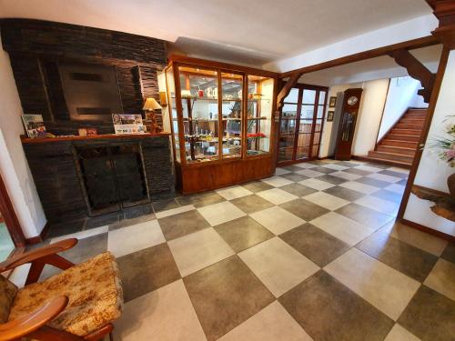 a living room with a checkerboard floor and a bar at Hotel La Cumbrecita in La Cumbrecita