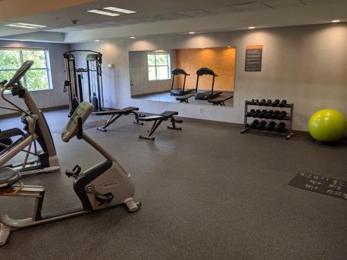a gym with tread machines and a large exercise ball at La Quinta by Wyndham Montgomery in Montgomery