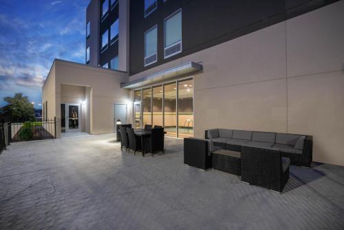 a building with a couch and chairs in front of it at La Quinta by Wyndham West Memphis in West Memphis