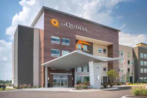 a hotel with a sun sign on the front of it at La Quinta by Wyndham West Memphis in West Memphis