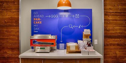 a display in a store with a table with a coffee maker at Holiday Inn Express & Suites - Marion by IHG in Marion