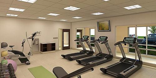 a gym with treadmills and ellipticals in a room at Holiday Inn Express & Suites - Marion by IHG in Marion