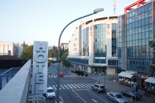 a view of a city street with a hotel sign at Hotel Bojatours in Podgorica