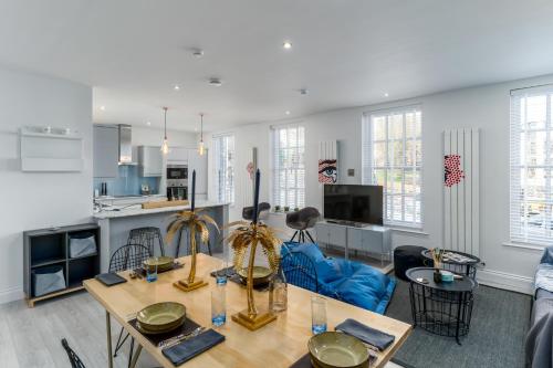 a living room with a table and a kitchen at Nadler House Flat 1 & 2 in Norwich